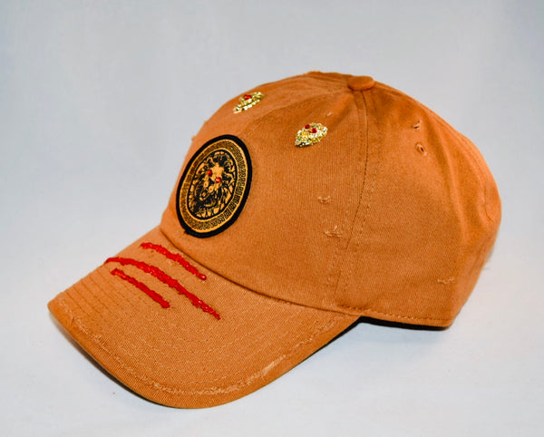 Signature Ruby Eye Lion-Emblem Medallion Tan Cap